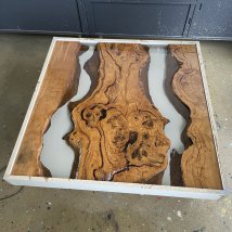 Coffee table in production, casting of resin in a tank